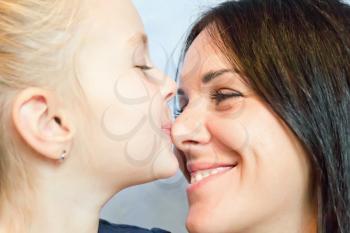 Photo of kissing happiest mother and daughter