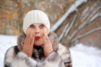 Portrait of surprised woman in winter coat