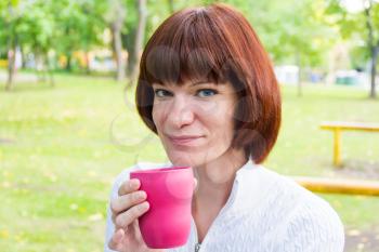 Photo of woman with brown hair drinking tea