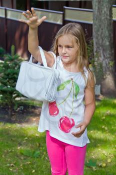 Cute girl playing with white bag in summer