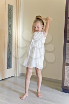 Photo of cute dancing girl in white