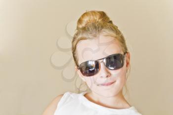 Cute girl playing with sunglasses