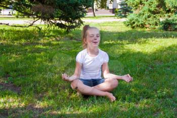 Photo of cute girl in lotus pose with sore knee