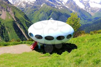 Image of landscape with Caucasus mountains and UFO