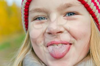 Portrait of cute girl with put out tongue