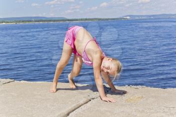 Photo of girl practices yoga in pose footbridge