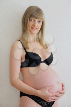 Photo of pregnant woman in black underwear