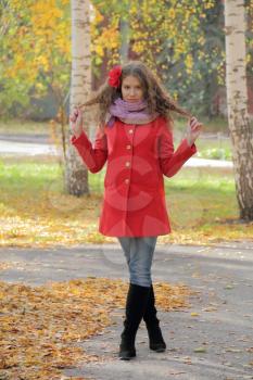 Image of beautiful young woman in red coat