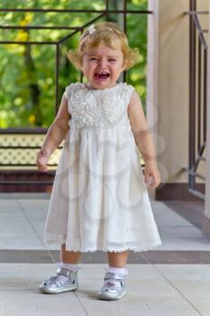 Cute crying baby girl with blond hair