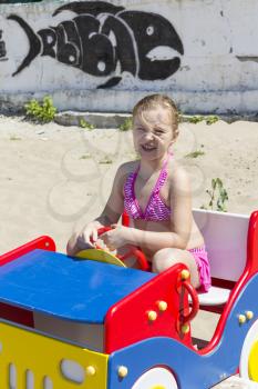 Cute girl at playground on the beach