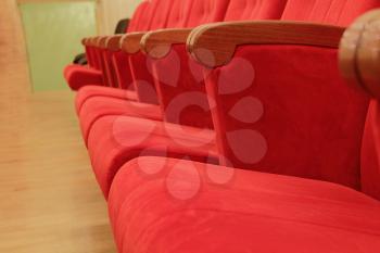 Background of many red theatrical red chairs