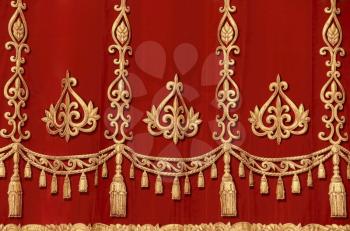 Theatrical red velvet curtain with gold pattern
