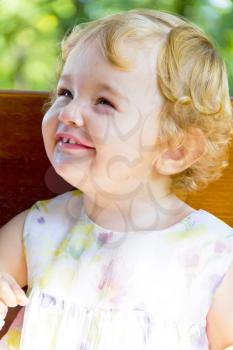 Portrait of smiling baby girl with curly blond hair
