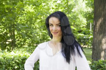 European woman with black hair on green background