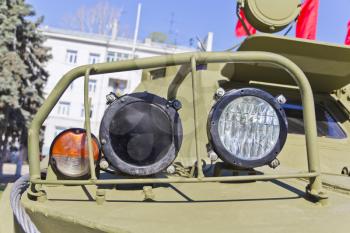 Headlight of military machine at the exhibition under open sky