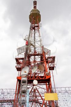 Vertical photo of cell tower and radio antenna