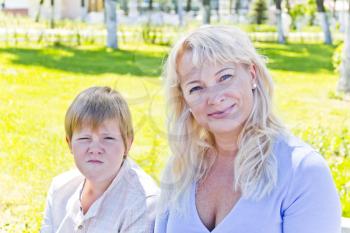 Portrait of European beautiful woman with pose face son in park
