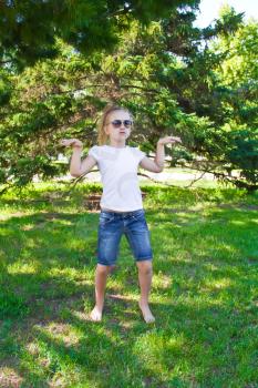 Photo of cute dancing girl with sunglass in summer