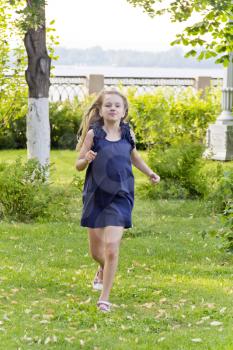 Cute running European girl with disheveled hair in summer