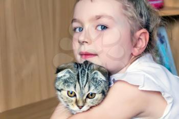 Blond girl with grey kitty in white