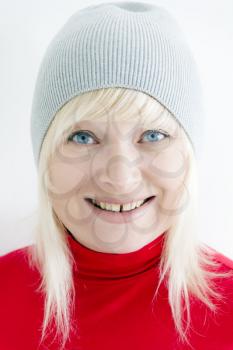 Blond woman with blue eyes in grey hat