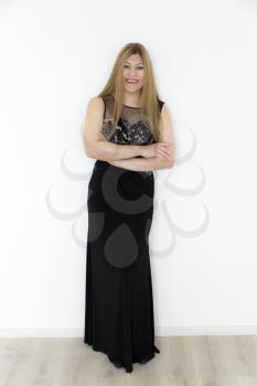 Attractive young girl with brown healthy straight hair in evening black long dress