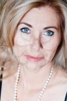 Vertical portrait blond woman with pearl beads
