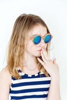 Cute girl eleven years old  in green sunglasses on white
