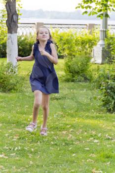 Vertical photo of cute running European girl with disheveled hair