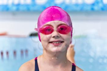 Portrait of smiling cute girl in swimming pool