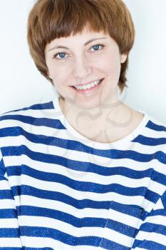 Portrait of smiling woman with short brown hair and blue eyes