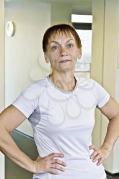 Elderly woman with a short haircut in the gym