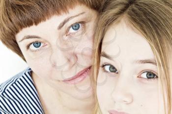 Portrait of happiest mother and daughter with blue and green eyes