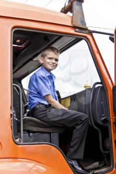 Cute smiling boy are sitting in fire engine