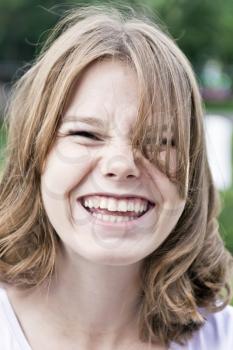 Portrait of laugh blond girl fourteen years old