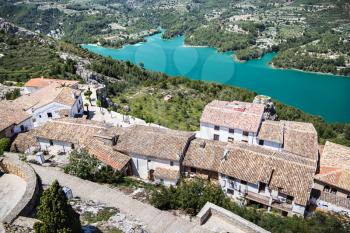 Guadalest lake and village. Reservoir and tiling roofs. Photo.