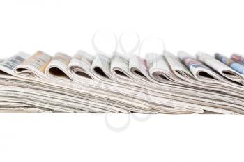 Assortment of folded newspapers isolated on white