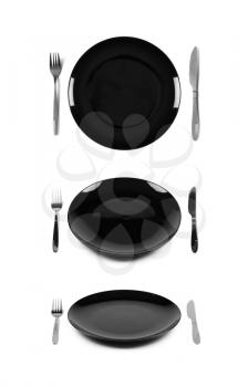 Black plate with fork and knife. Isolated on white. Three angles of view.