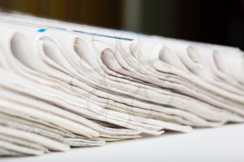 Assortment of folded newspapers closeup. Shallow DOF.