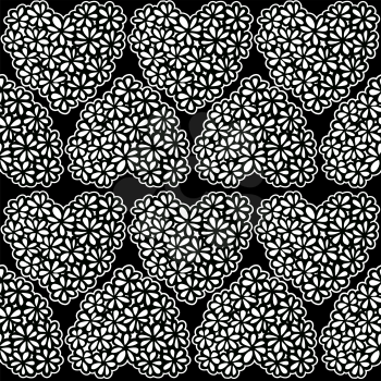 Seamless texture with white and black flower filled hearts.