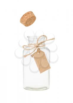 Cork pop out from bottle with label. Isolated on white.