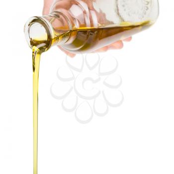 Male hand holding a bottle. Oil pouring from a bottle.