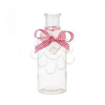 Empty bottle with heart shaped tag and red bow isolated on white