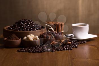 Still-life with coffee, cup with saucer, coffee beans and spices.