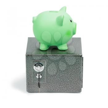 Green ceramic piggy bank standing on a safe, isolated on white background. Ecology investment, money for sustainable green energy, saving on costs, save the Earth concept.