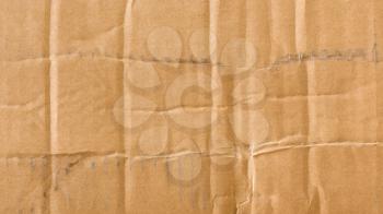 Old wrinkled cardboard with visible marks. Background of grunge worn down texture