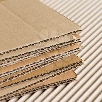 Cardboard pile on corrugated cardboard texture background.