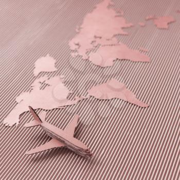 Airplane and world map made of cardboard. Square format, selective DOF. Red colorized.