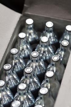 Soda chargers in carton box. Selective DOF, cole up shot.