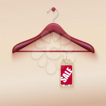 Red tag with sale sign hanging on wooden hanger